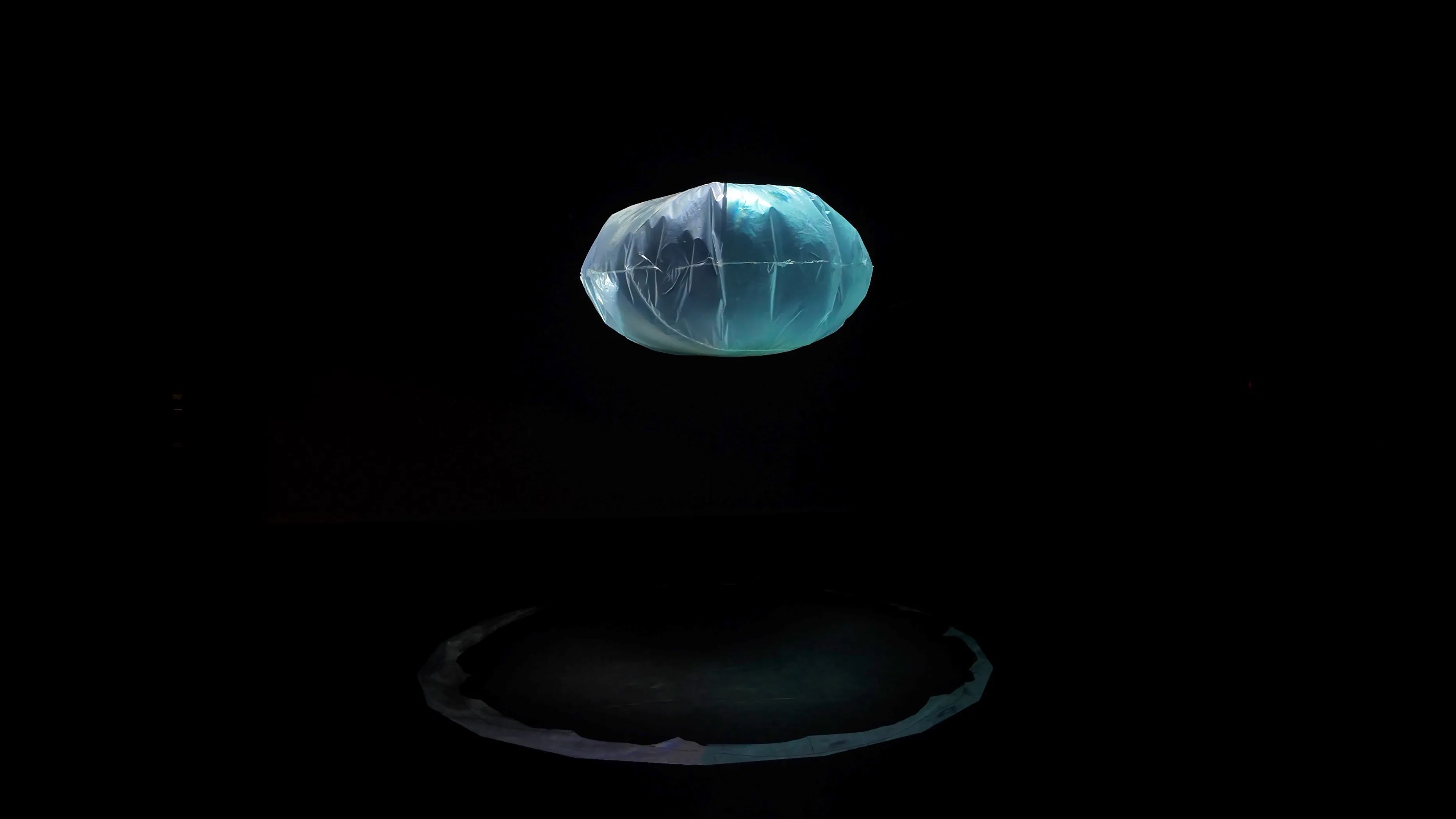 The bubble floating casting a rim of light on the floor