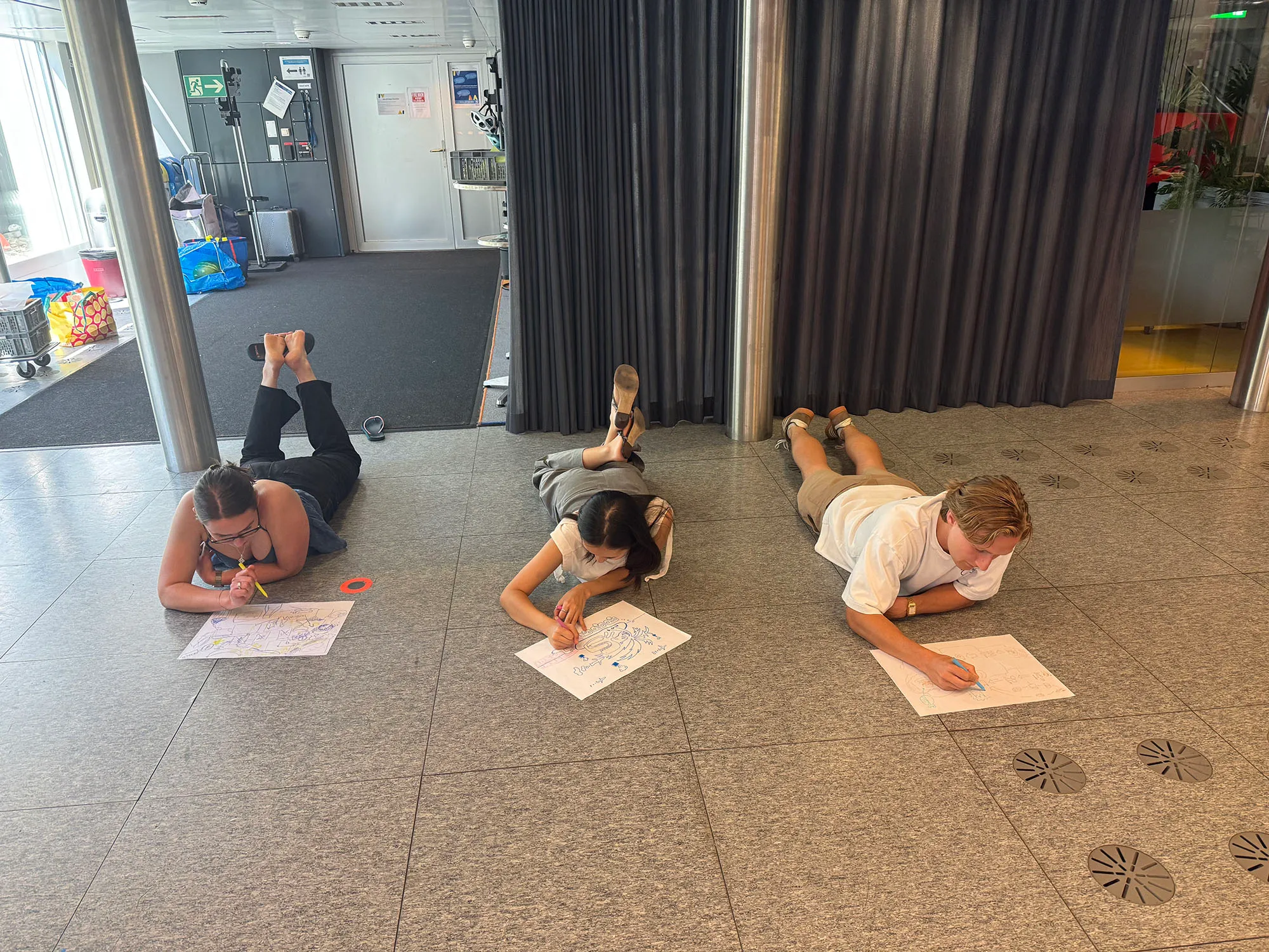Stefanie, Samantha and Thomas lying on the floor during the last day of WFSC Summer School